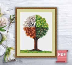 the cross stitch pattern shows an image of a tree with oranges and green leaves