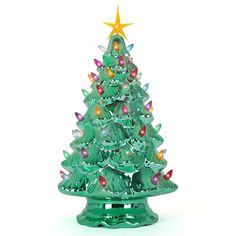 a green glass christmas tree with lights on it's sides and a star on top