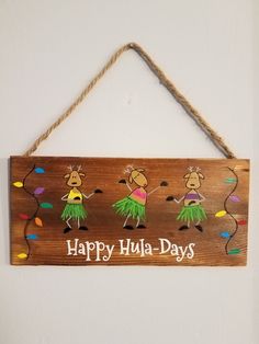 a wooden sign that says happy hula - days hanging on a wall with string