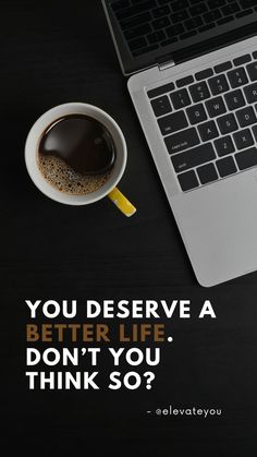 a laptop computer sitting on top of a desk next to a cup of coffee