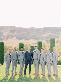 a group of men in suits standing next to each other