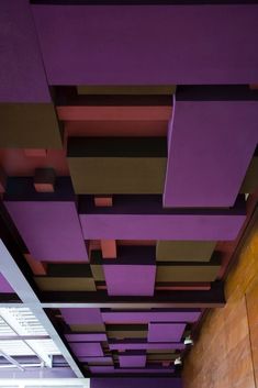 an empty room with purple walls and wooden flooring on the ceiling is seen in this image