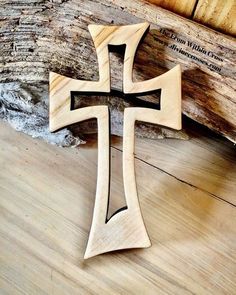 a wooden cross sitting on top of a wooden floor