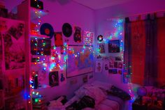 a bedroom with lights and pictures on the wall