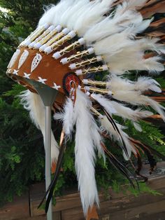 Short Brown Indian Headdress Replica made with rooster dyed feathers and shell white work in the front This great adult headdress is entirely handmade and truly adorable. Perfect photography prop for your special ocasion. Ties in the back for a perfect fit. This will be precious for your costume, or even room decor. Head circumference: 59 centimeters / 23 inches ✈️ Worldwide shipping 🐤 I only use authentic feathers ⛺️ I guarantee highest quality, 100% hand-crafted White Bohemian Ceremonial Headpiece, White Bohemian Costume Hats And Headpieces For Festivals, White Headpieces For Carnival Festival, White Bohemian Costume Hat For Festivals, Bohemian White Headpiece For Festival, Ceremonial White Handmade Headpieces, Handmade White Headpieces For Ceremonial Events, Ceremonial Handmade White Headpiece, Perfect Photography