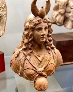 a statue of a woman with horns on her head