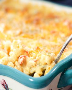 a blue dish filled with macaroni and cheese