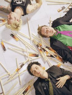 two men laying on the ground with lots of matchesticks in front of them