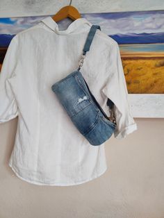 denim shoulder bag in cylinder shape from recycled blue jeans. the mini barrel bag has metal zipper closure and removable denim shoulder strap. this size may hold: phone, sunglasses, keys, small wallet, cards and few makeup. the purse has blue cotton interior lining with one small slip pocket. on the exterior there are also the 5 jeans pockets. the small geometric purse is handmade from repurposed blue denim jeans with hand stitch visible mending. it is not a stiff bag however the body of the ba Luxury Denim Blue Shoulder Bag With Removable Pouch, Cheap Blue Upcycled Shoulder Bag, Cheap Denim Blue Bag With Zipper Closure, Luxury Denim Blue Bag With Removable Pouch, Cheap Denim Bags With Removable Pouch, Cheap Upcycled Denim Blue Shoulder Bag, Diy Jeans Bag Tutorial, Denim Jeans Recycled, Recycled Handbag