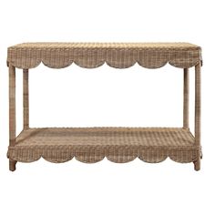 a wicker shelf with scalloped edges on the top and bottom, against a white background