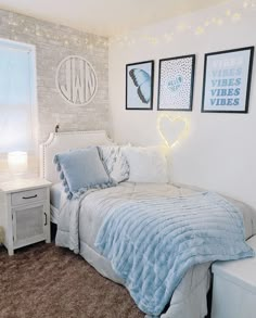 a bedroom with two pictures on the wall and a bed in front of a window