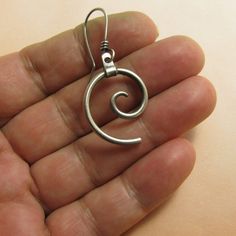 "Spiral earrings crafted from argentium sterling silver are thoroughly modern but timeless. The spiral, from dust devils to hurricanes, tornadoes, whirlpools, and electrons, even our galaxy follows the path of a spiral, the most fundamental pattern in nature. Pair these contemporary spiral earrings with anything in your closet, they are so versatile! Metalsmithed from hefty 12 gauge argentium sterling silver and the ear wires are standard 20 gauge. Lightly oxidized and polished to finish, metals Minimalist Sterling Silver Swirl Earrings, Minimalist Silver Swirl Earrings, Unique Sterling Silver Swirl Earrings, Minimalist Silver Spiral Earrings, Pattern In Nature, Metalsmith Jewelry, Our Galaxy, Sterling Silver Owl, Earrings Nature