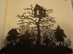 an open book with a drawing of a tree house