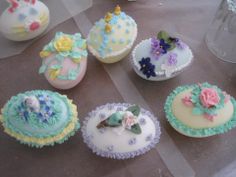 several decorated cupcakes sitting on top of a table