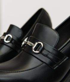 These chic beauties combine the classic flair of loafers with a stylish heel, making them perfect for both the office and after-hours outings. The soft leatherette material hugs your feet comfortably, while the sleek metal chain detail adds just the right touch of sophistication. With their versatile black hue, you can easily pair them with anything! Complete with a 4 inch heel..Available while supplies last. | Black Leatherette Loafer Heels | Size 7 Loafer Heels, Stylish Heels, Size 11 Heels, 4 Inch Heels, After Hours, Heeled Loafers, Metal Chain, Unique Vintage, The Office