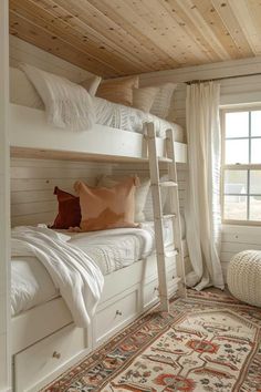 a bedroom with bunk beds and rugs on the floor in front of a window