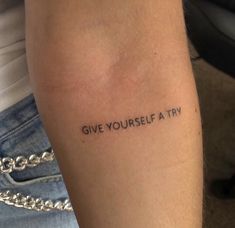 a person with a tattoo saying give yourself a try