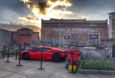 a red sports car parked in front of a building