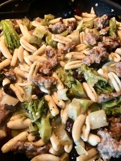 pasta with sausage and broccoli in a skillet