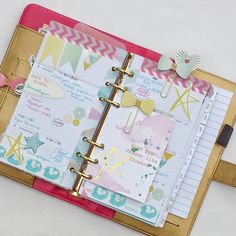 an open planner book sitting on top of a table