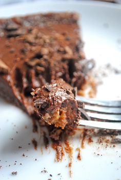 a piece of chocolate pie on a plate with a fork