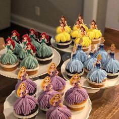 some cupcakes that have been decorated to look like disney princesses on them