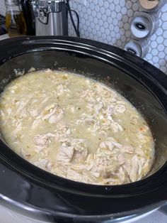 a crock pot filled with food sitting on top of a stove