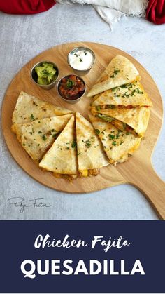 chicken fajita quesadilla on a cutting board with salsa and guacamole