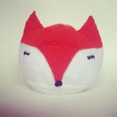 a knitted hat with a red and white fox face