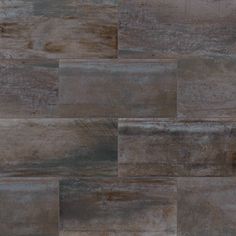 an image of a tile floor with brown and gray tones on it's surface