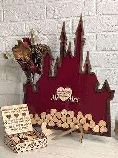 a couple of wooden pieces sitting on top of a table next to a vase with flowers