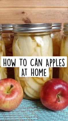 three jars filled with apples sitting on top of a table next to an apple slice