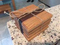 a stack of wooden coasters tied with twine on top of a kitchen counter