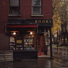 a book store sitting on the side of a street next to a tall brick building