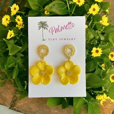 Delicately crafted by hand, these molded yellow flower clay earrings are a true testament to artisanal creativity. Each earring features intricate details, capturing the essence of a blooming flower with precision and elegance. The hue of the clay exudes a charming and feminine allure. The addition of stamen accents further enhances the lifelike appearance of these unique earrings, making them a standout accessory. Wearing these handmade earrings is like wearing a piece of nature, bringing a subtle yet striking beauty to your ensemble. Add a floral flourish to your look with these one-of-a-kind clay earrings. Made with hypoallergenic posts.  Care instructions:  Avoid using aerosol products, perfumes, jewelry cleaners or chemicals near the jewelry. Clean with a soft damp cloth or baby wipe. Gold Flower-shaped Polymer Clay Earrings, Yellow Earrings With Flower Charm For Gift, Yellow Flower Charm Earrings As Gift, Yellow Flower-shaped Polymer Clay Earrings, Handmade Yellow Flower Earrings For Gift, Handmade Yellow Flower Earrings, Yellow Handmade Flower Earrings, Yellow Flower-shaped Earrings With 3d Flowers, Yellow Flower-shaped Jewelry With 3d Flowers