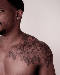 a man with a flower tattoo on his chest