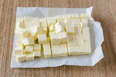 cubes of butter sitting on top of a piece of wax paper