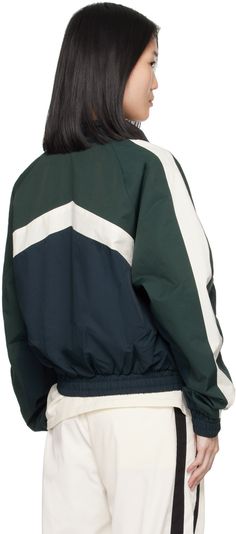 Nylon- and cotton-blend twill track jacket. Stripes throughout. · Paneled construction · Stand collar · Half-zip closure · Rubberized logo bonded at chest · Welt pockets · Elasticized hem and cuffs · Raglan sleeves · Full satin lining Supplier color: Navy/Dark green/White Sporty Track Jacket With Zip Cuffs For Fall, Sporty Nylon Track Jacket With Zip Cuffs, Sporty Nylon Track Jacket With Zipper Closure, Sporty Nylon Track Jacket With Zipper, Sporty Green Track Jacket With Zipper Closure, Track Jacket, Track Jackets, Welt Pockets, Half Zip