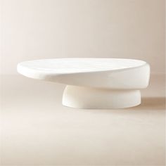 a white table sitting on top of a beige floor