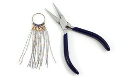 a pair of scissors with tassels attached to them