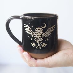 Sip your morning brew in style with this handmade Owl + Oak mug! With a great grey owl swooping over oak leaves and acorns in a starry night sky, this farmhouse-style mug adds a unique rustic touch to your coffee ritual. This outdoorsy mug is the perfect vessel to help you celebrate your inner wisdom and bring the transformation you seek. Owl Swooping, Oak Leaves And Acorns, Farmhouse Mugs, Grey Owl, Custom Gift Cards, Coffee Ritual, Great Grey Owl, Brown Clay, A Starry Night