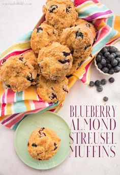 blueberry muffins on a plate next to a cup of coffee and berries