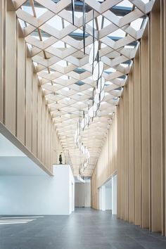 an empty hallway with wooden walls and ceiling