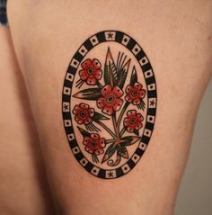 a close up of a woman's thigh with flowers on it