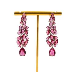 Long earrings can add a touch of elegance and glamour to any outfit, especially when dressing up for a night out. These beautiful fuchsia earrings are a perfect example of how accessories can enhance your overall look. The bold color of these earrings will make them stand out and draw attention to your face, while the length will add a sense of drama and sophistication. When wearing long earrings, it's important to keep the rest of your jewelry minimal so that the earrings can be the star of the Luxury Ruby Earrings For Evening, Elegant Red Earrings For Party, Luxury Pink Dangle Earrings, Ruby Chandelier Drop Earrings For Party, Luxury Red Earrings For Party, Elegant Pink Chandelier Earrings For Formal Events, Elegant Pink Chandelier Earrings For Formal Occasions, Luxury Pink Drop Earrings, Formal Pink Chandelier Earrings