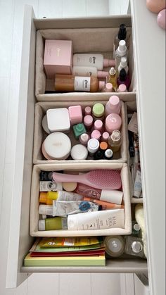 an open drawer filled with cosmetics and personal care items