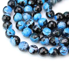 blue and black glass beads on white background