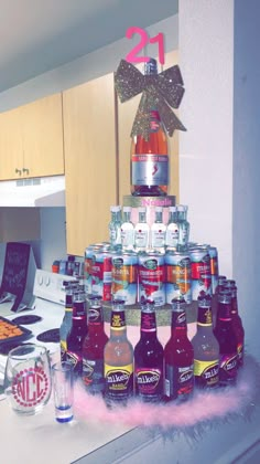 a cake made out of beer bottles on top of a counter with other items around it