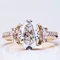 This opulent 1.50 ct. Oval Diamond Engagement Ring exudes luxury with its meticulously crafted design. The centre oval-cut diamond is embraced by a lavish 2 half moon cut diamonds, creating a radiant display of sparkle. The setting, adorned with additional diamonds, adds a touch of sophistication, making it an exquisite symbol of enduring love and refinement. 💎 Centre stone:- ➼ Type: Natural Diamond / Lab-grown Diamond (CVD) ➼ Shape/Cutting type: Oval brilliant cut ➼ Size: Approx. 8.5x6.5 mm ➼ Half Moon Diamond, Oval Diamond Solitaire, Diamond Wedding Anniversary, Engagement Ring Women, Moon Cut, Wedding Anniversary Ring, Statement Rings Diamond, Gold Promise Rings, Oval Diamond Engagement Ring