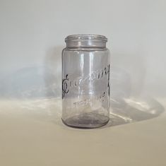 an empty glass jar sitting on top of a table